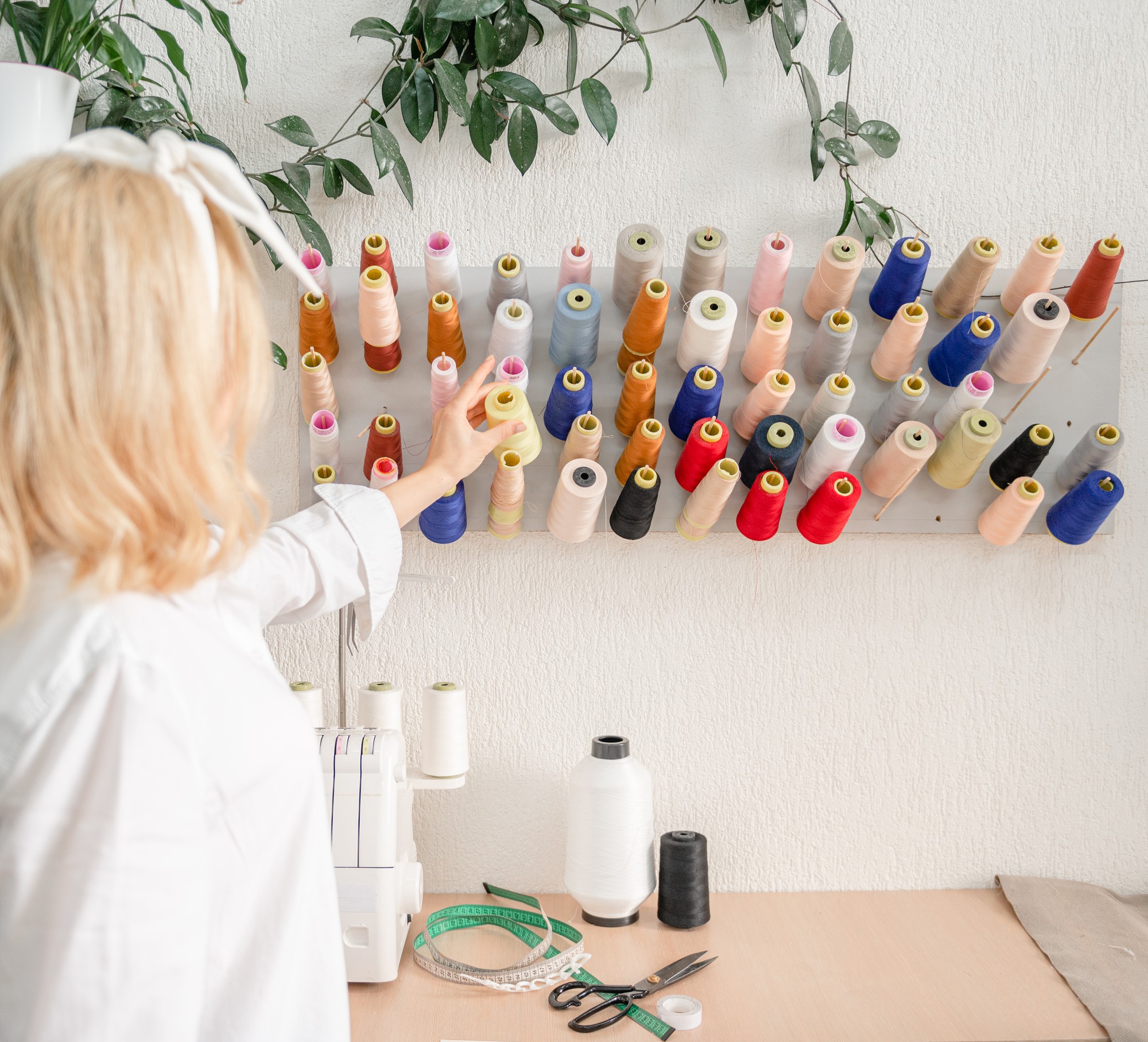Studio workspace with embroidery machines and threads